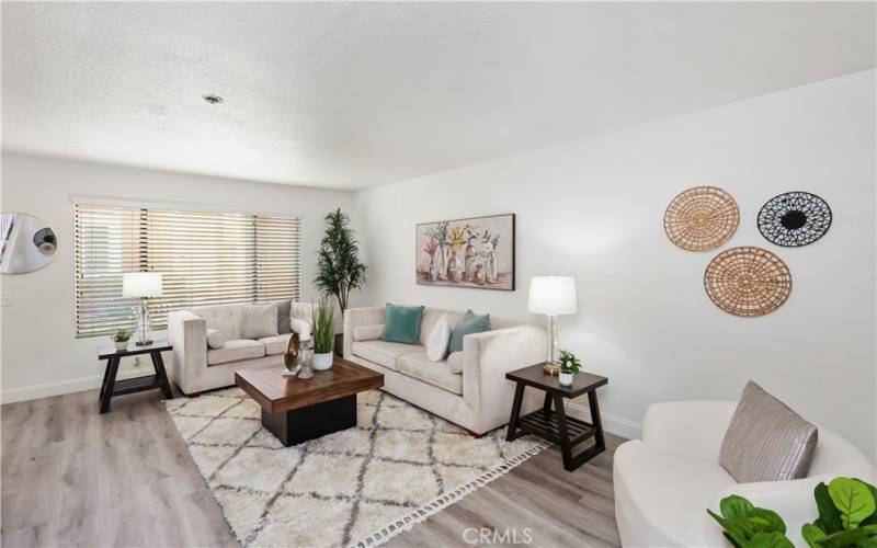 The large living room window allows light to naturally brighten the downstairs space.