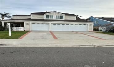 3 Car Garrage and Spacious driveway lined with fruit trees.