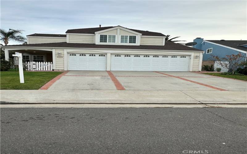 3 Car Garrage and Spacious driveway lined with fruit trees.