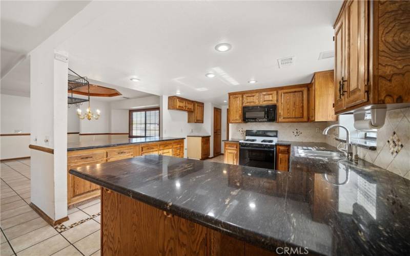 Granite counters, oak cabinets & stainless steel sink