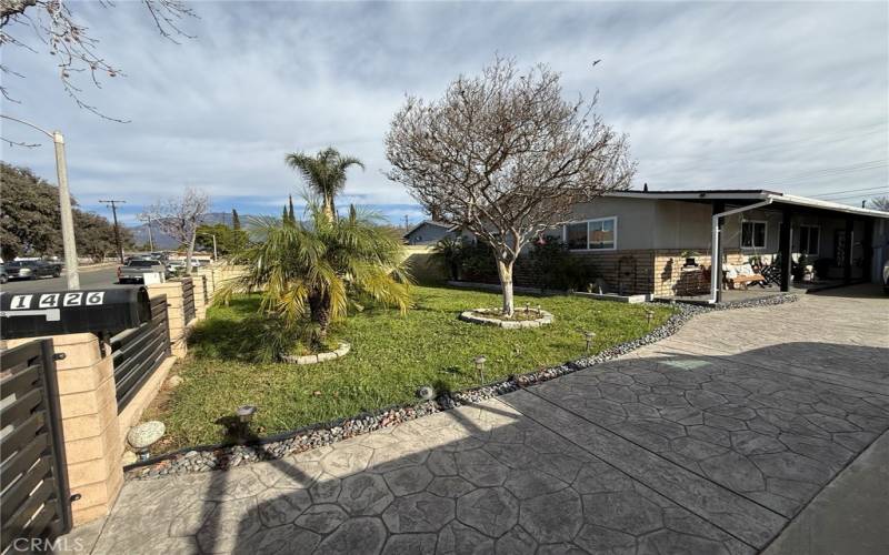 Gated front yard with mature trees.