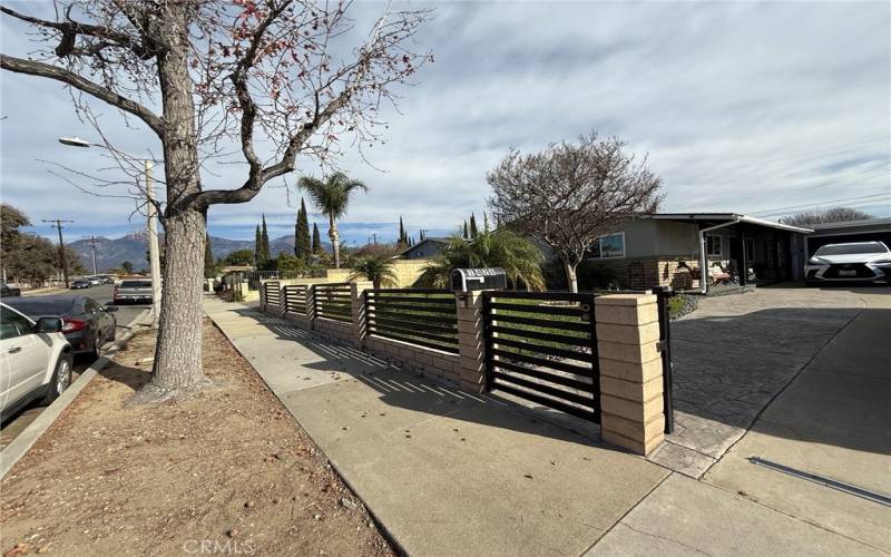 Gated front yard with sliding gate for driveway.