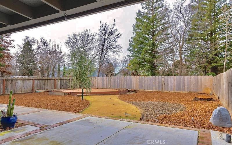 Backyard view from covered patio - floating deck in back corner