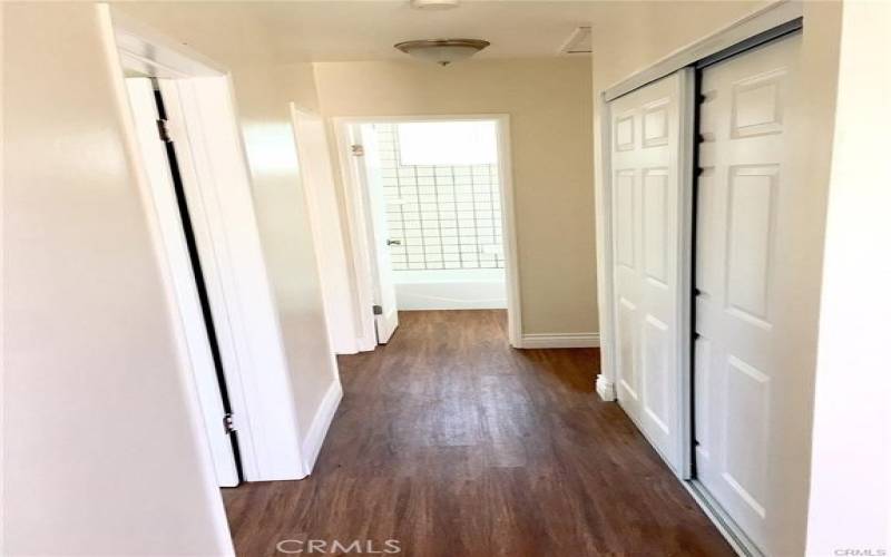 HALL WAY LOOKING TOWARDS BATHROOM. BEDROOMS ON THE LEFT. EXTRA STORAGE TO THE RIGHT.