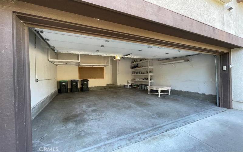 Upper storage racks in the garage and built-in shelving.