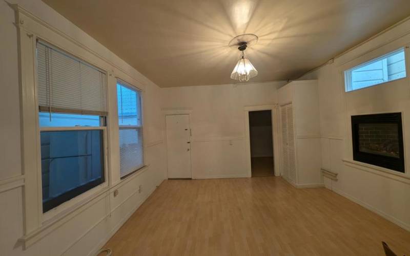 Multiple windows with plenty of natural light with a fireplace makes this a cozy living room.