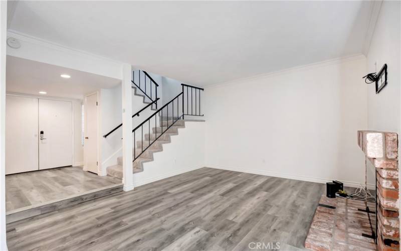 Living room; fire place to the right; newer engineered flooring; ALL NEW PAINT INSIDE