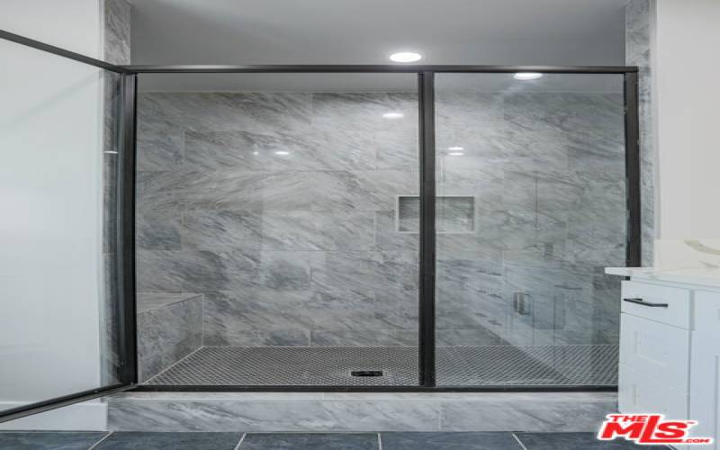 Oversized master bathroom shower with stoop