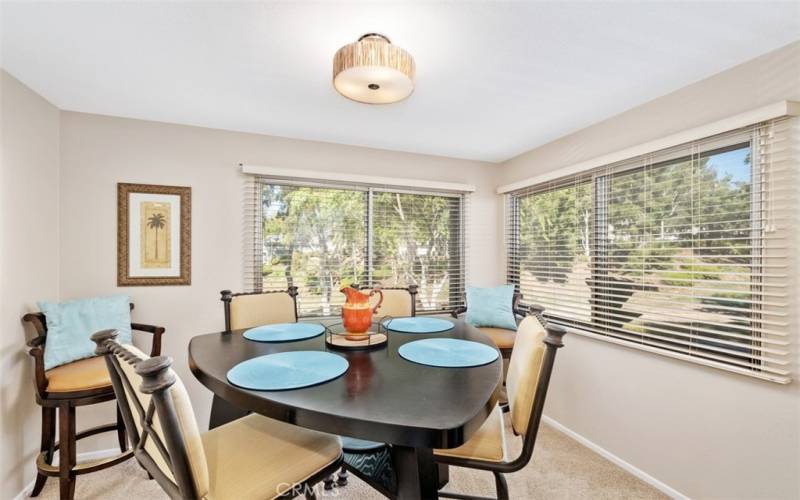 Dining area with an elegant high-top table and chairs with view of the trails