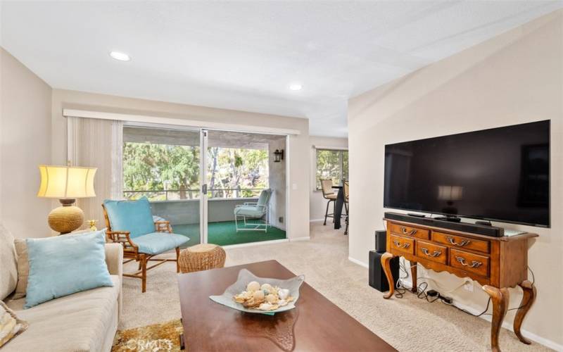 Living room facing the balcony; extra large Smart TV and Massage Chair