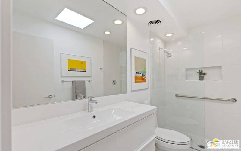 The hall bath has been updated with porcelain tile creating a walk-in shower.