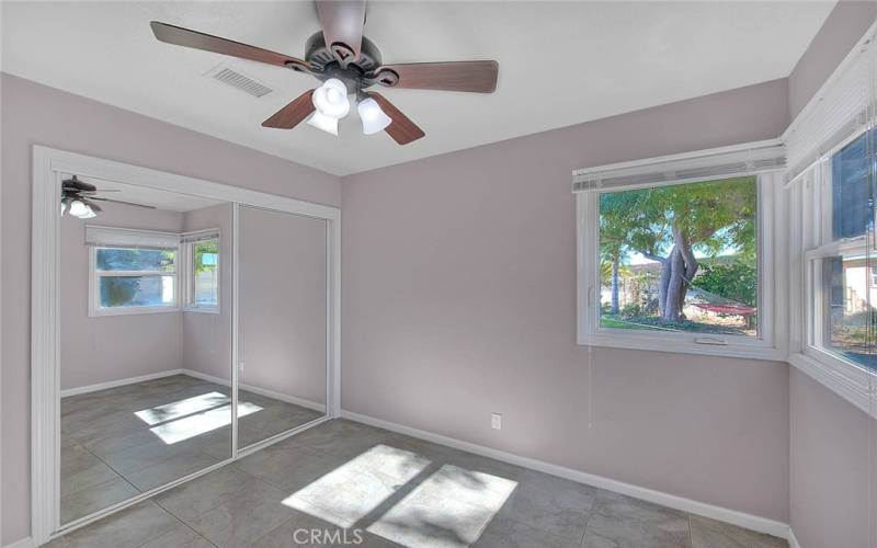 Tile floor in the bedroom, mirrored closet doors