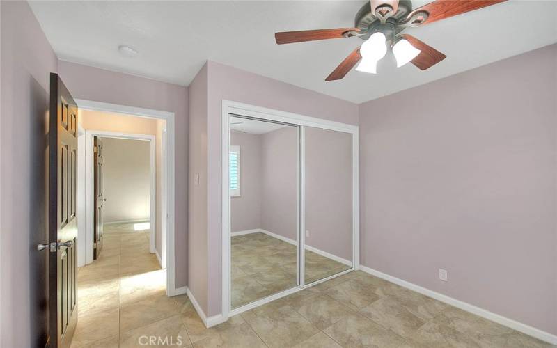 Another secondary bedroom, tile floors and ceiling fan.