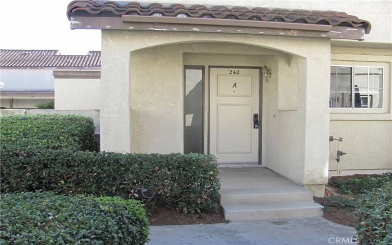 The front door backs to the Carport #242