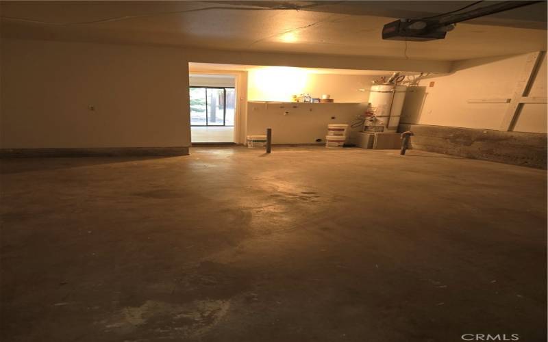 Garage, with Washer/Dryer Hookups in View along with the Water Heater
