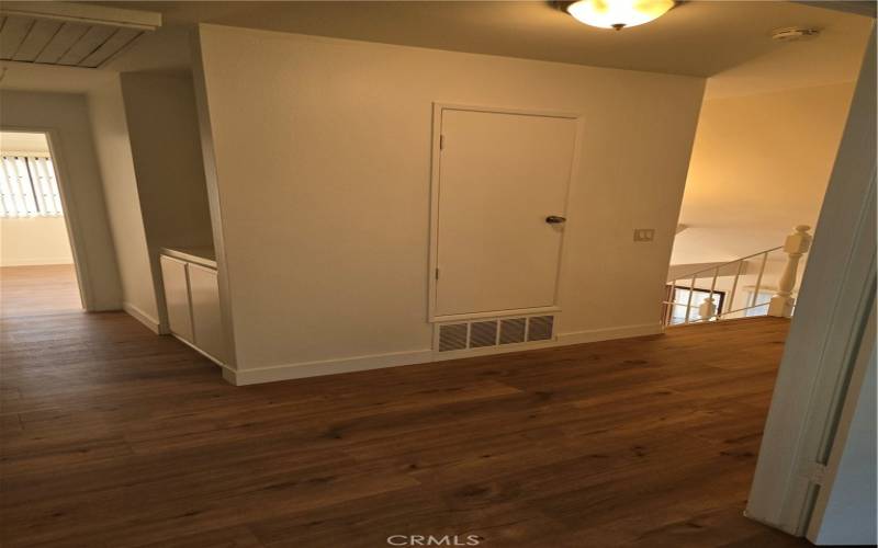 Upstairs Hallway outside Master Bedroom Double Entry Doors, with bedrooms visible to the left and stairs to the right.