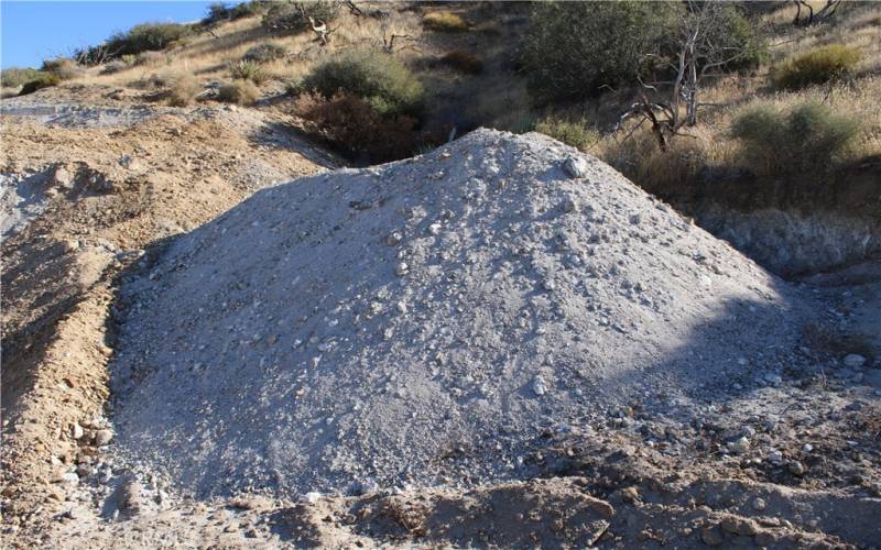 Stockpiled decomposed granite excavated from land