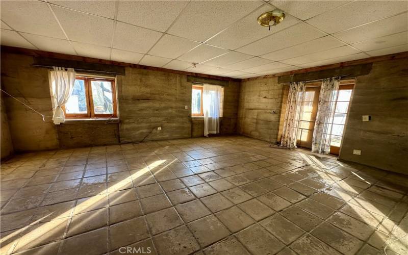 The bedroom has natural light with French doors to the yard.