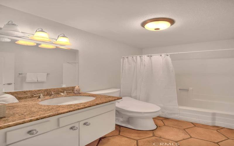 Guest/Hall Bathroom with a Tub/Shower and Granite Counters