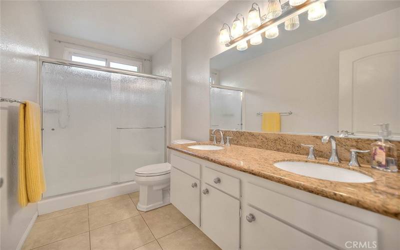 Primary Bathroom with a Shower and Dual Sinks