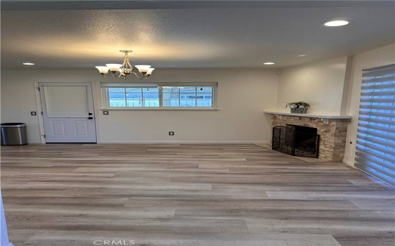 Dining/family area with fireplace and sliding door to backyard.