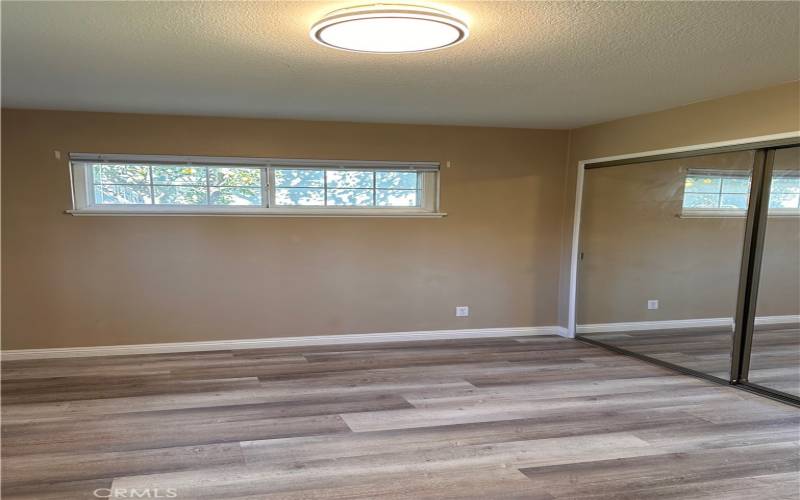 Master bedroom mirrored closet with light inside.