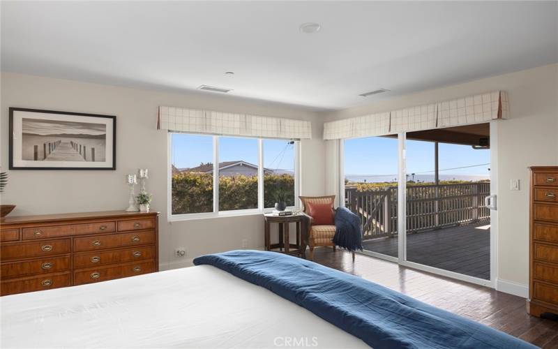 Wake up to ocean views. This view of the ocean is from the primary bedroom. Sliding glass doors to covered balcony provide sea breezes.