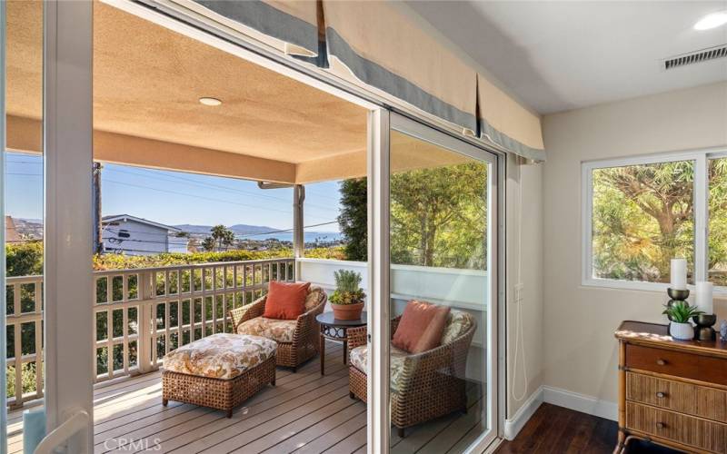 Sliding glass doors from living room and dining area open to a covered balcony, where you can enjoy ocean views in serene privacy. This is a great place to enjoy a cup of coffee in the morning or a glass of wine at the end of the day.