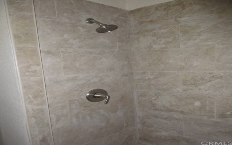 New plumbing shower stall with brushed nickle fixtures