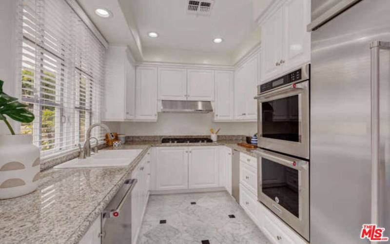 Gourmet kitchen offers granite countertops, stainle steel appliance package and built-in cabinetry.