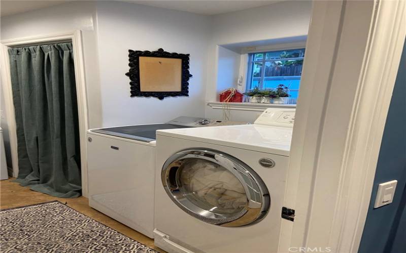 Private laundry room off of kitchen.